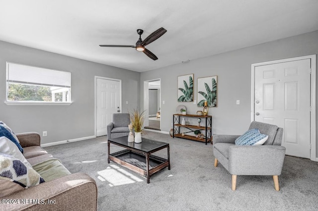 carpeted living room with ceiling fan