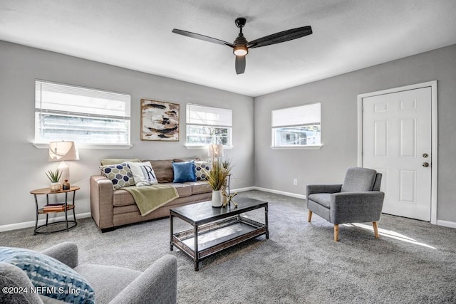 carpeted living room with ceiling fan