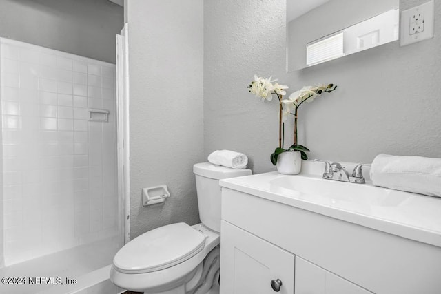 bathroom featuring vanity, toilet, and walk in shower