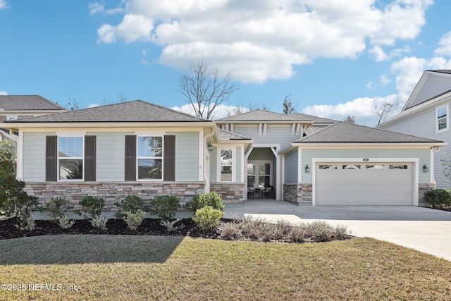 view of front of house featuring a garage and a front lawn