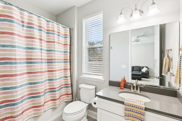 full bathroom with vanity, toilet, ceiling fan, and shower / tub combo