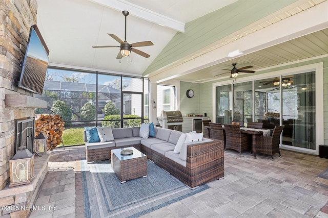 sunroom / solarium featuring ceiling fan and beamed ceiling