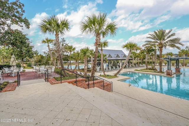 view of pool with a patio and a pergola