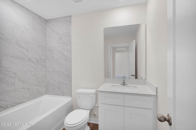 full bathroom featuring vanity, toilet, and tiled shower / bath