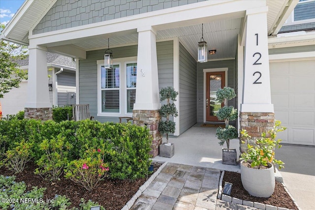 view of exterior entry with covered porch