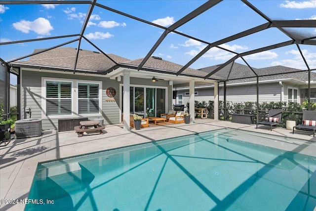 view of swimming pool with central AC unit, a lanai, a patio area, and ceiling fan