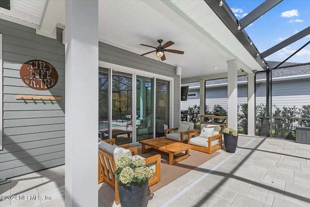 view of patio featuring a lanai and ceiling fan