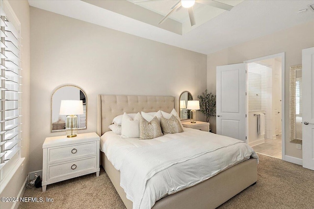 carpeted bedroom with ceiling fan and ensuite bathroom