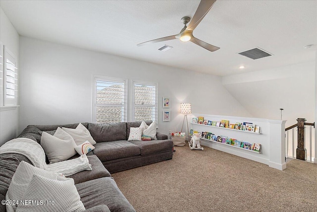 living room featuring ceiling fan and carpet