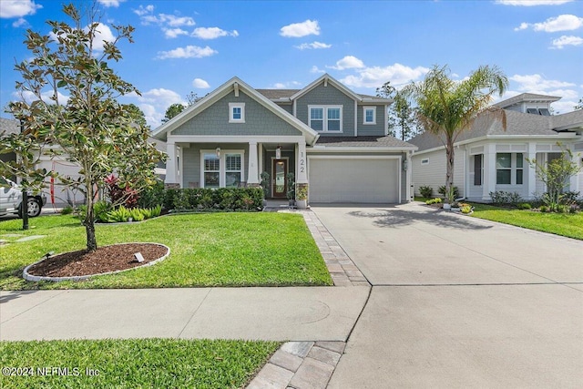 view of front of property featuring a garage and a front lawn