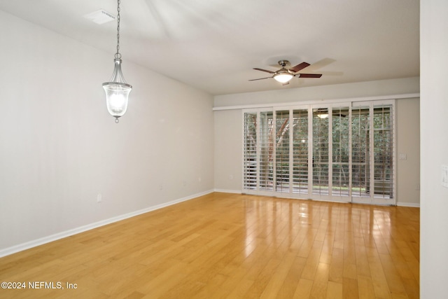 spare room featuring hardwood / wood-style floors and ceiling fan