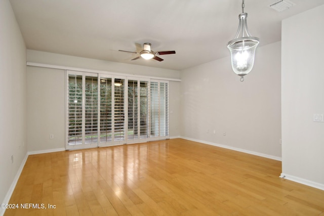 empty room featuring hardwood / wood-style floors and ceiling fan