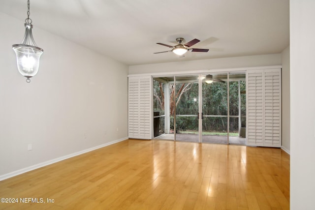 spare room featuring hardwood / wood-style floors and ceiling fan