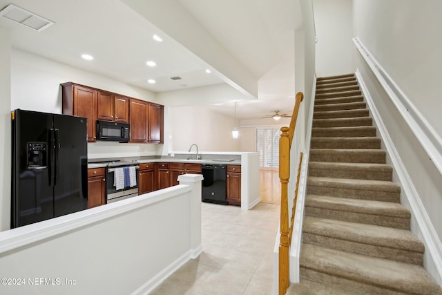 kitchen featuring kitchen peninsula, ceiling fan, sink, black appliances, and light tile patterned floors