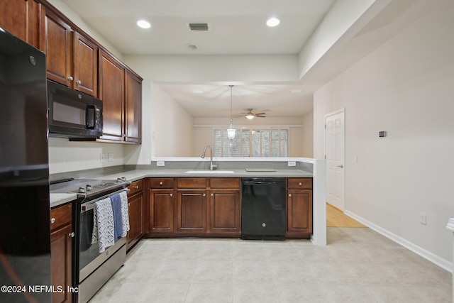 kitchen featuring kitchen peninsula, ceiling fan, sink, black appliances, and pendant lighting