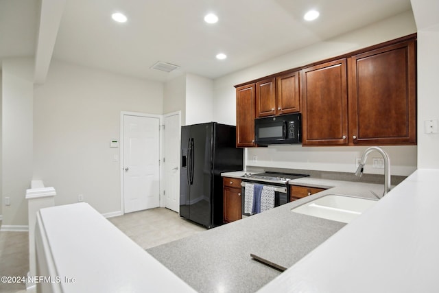 kitchen featuring sink and black appliances