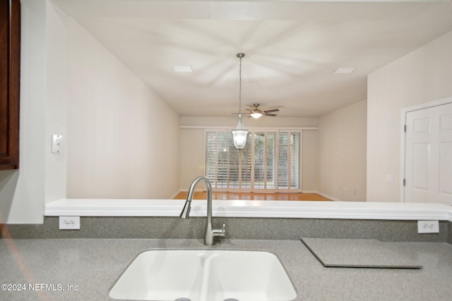 kitchen featuring pendant lighting, ceiling fan, and sink