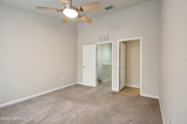 unfurnished bedroom featuring ceiling fan and light colored carpet