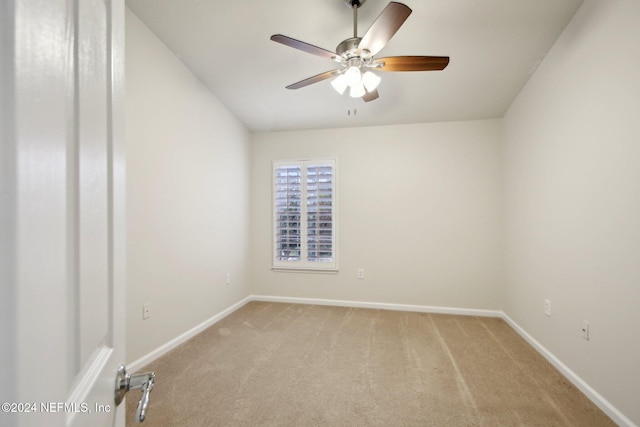 unfurnished room with ceiling fan and light colored carpet