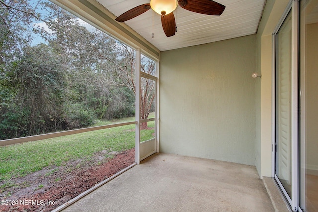 unfurnished sunroom with ceiling fan and a healthy amount of sunlight