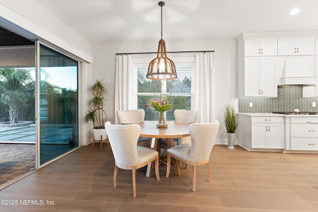dining area with recessed lighting and light wood-style flooring