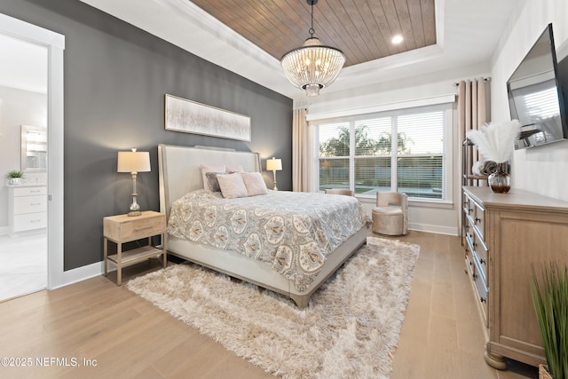 bedroom with wooden ceiling, wood finished floors, baseboards, a notable chandelier, and a tray ceiling