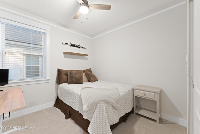 carpeted bedroom featuring baseboards, ornamental molding, and ceiling fan