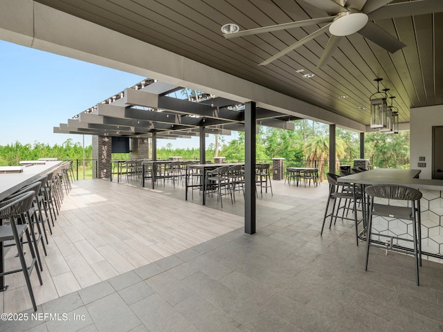 view of patio with a ceiling fan, outdoor dry bar, and a pergola