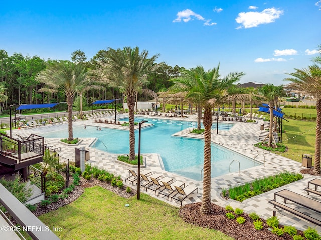 community pool featuring a yard and a patio area