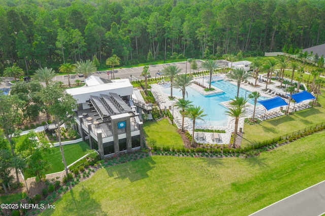 birds eye view of property featuring a view of trees