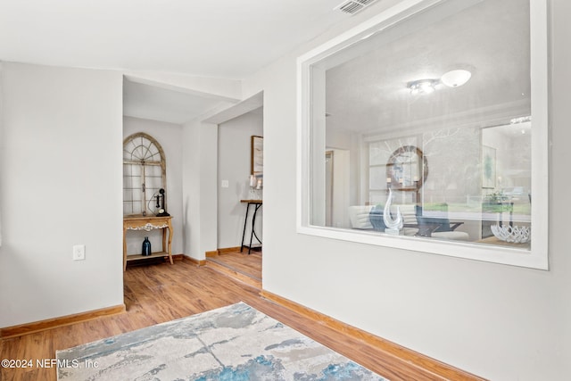 hall with hardwood / wood-style floors