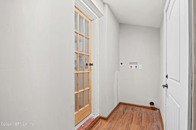 laundry area with electric dryer hookup, hardwood / wood-style floors, and washer hookup