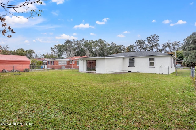 rear view of house with a lawn