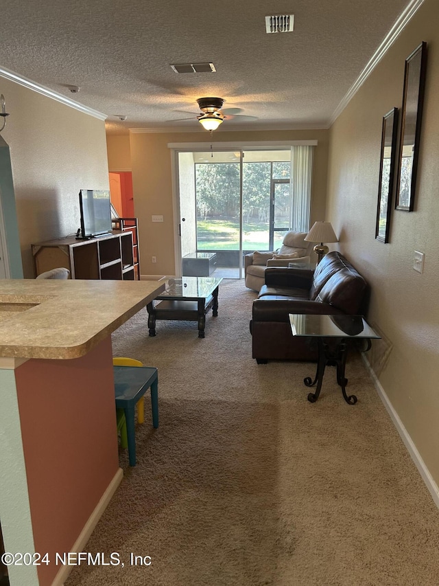 carpeted living room featuring crown molding, ceiling fan, and a textured ceiling