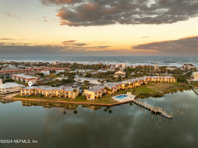 aerial view at dusk with a water view