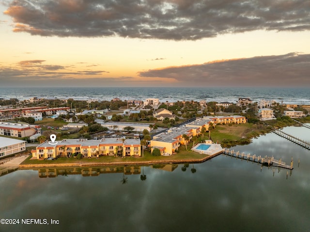 aerial view at dusk with a water view