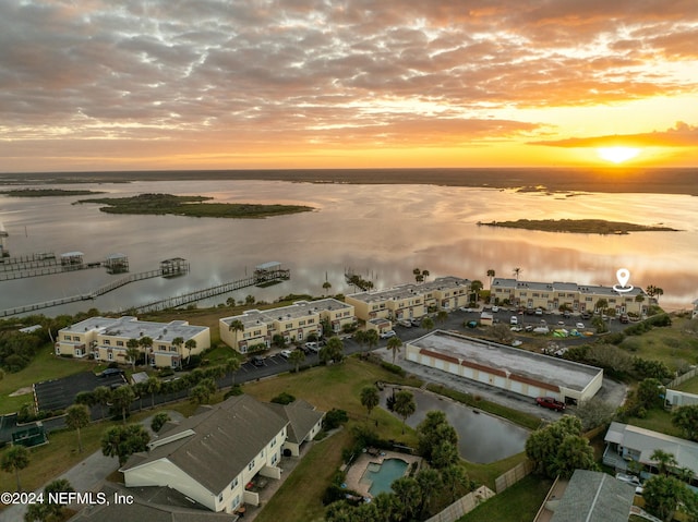 aerial view at dusk with a water view