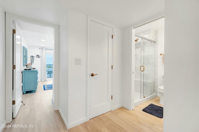 hallway with light hardwood / wood-style flooring