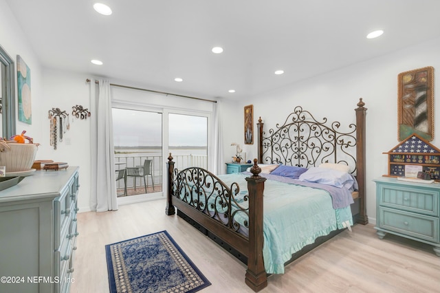 bedroom featuring access to exterior and light hardwood / wood-style flooring