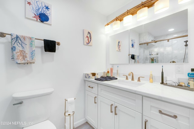 bathroom with walk in shower, vanity, and toilet