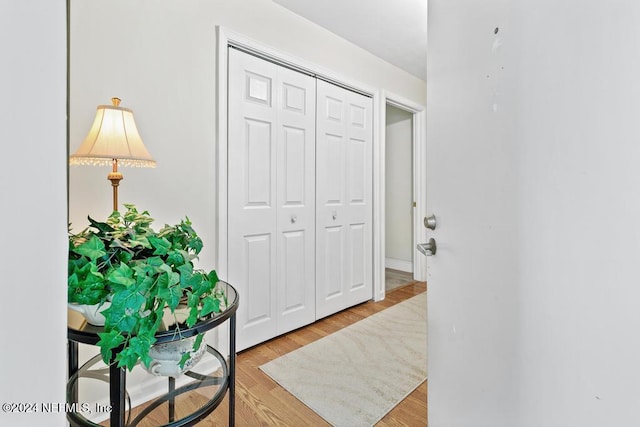 hallway with light hardwood / wood-style floors