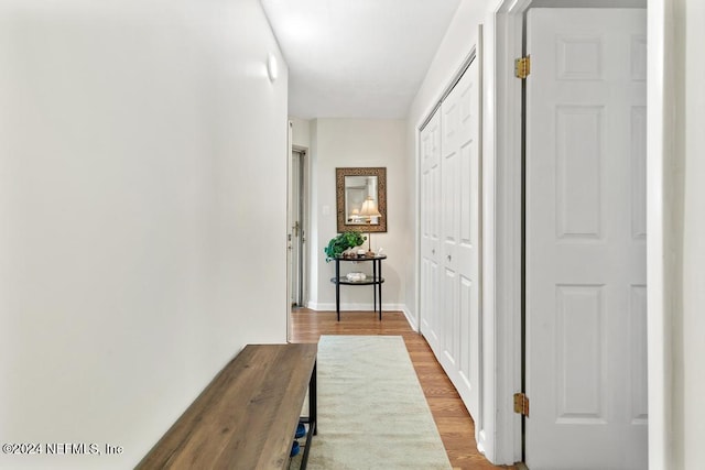 hall with light hardwood / wood-style floors