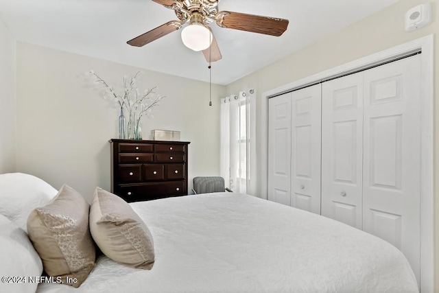 bedroom featuring ceiling fan and a closet