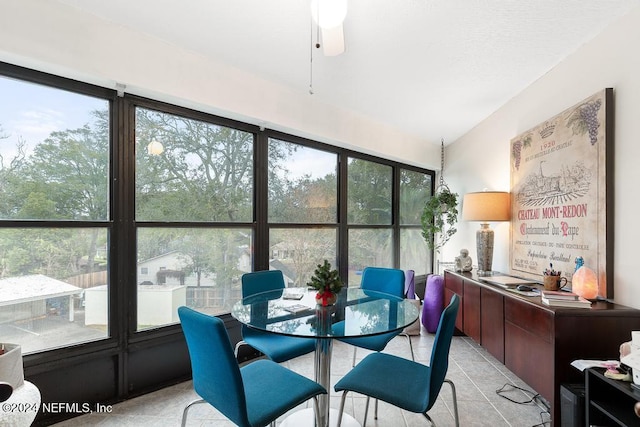 tiled dining room featuring ceiling fan