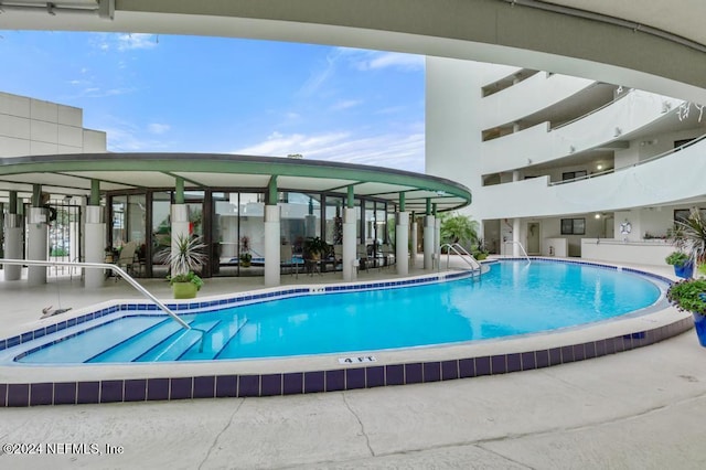 view of swimming pool with a patio area