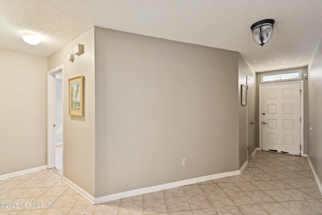 foyer entrance with a textured ceiling