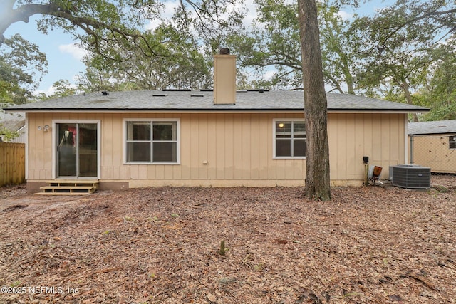 rear view of house featuring central AC