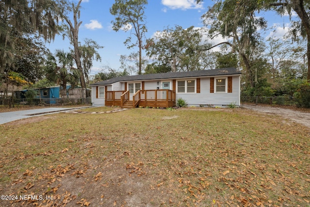 view of front of house featuring a wooden deck and a front lawn