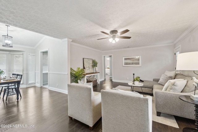 living room featuring crown molding, ceiling fan, dark hardwood / wood-style floors, a textured ceiling, and plenty of natural light