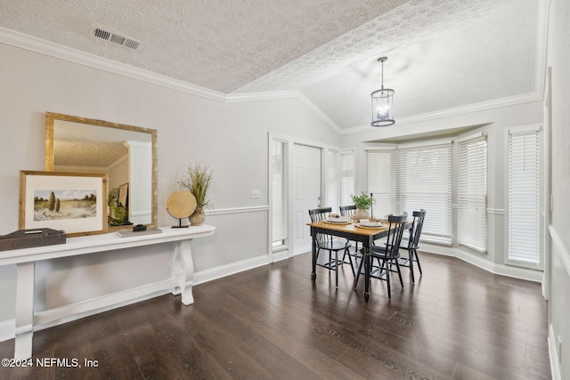 dining space with crown molding, a textured ceiling, and vaulted ceiling